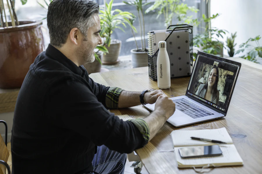 A man on a video call at his desk